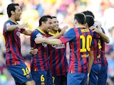 Barcelona's Alexis Sanchez is congratulated by team mates after tapping in the opening goal against Levante on August 18, 2013