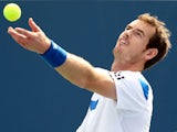 Andy Murray of Grerat Britain serves to Julien Benneteau of France during the Western & Southern Open on August 15, 2013