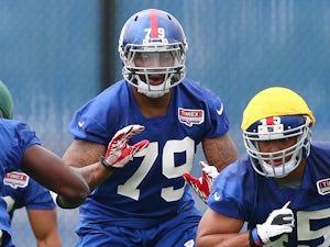 Damontre Moore of the New York Giants runs through a drill during the New York Giants Rookie Camp on May 11, 2013