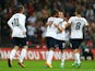 Theo Walcott of England celebrates with team-mate Tom Cleverley of England after scoring a goal during the International Friendly match between England and Scotland at Wembley Stadium on August 14, 2013