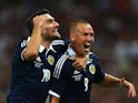 Kenny Miller of Scotland celebrates with team-mate Robert Snodgrass of Scotland after scoring a goal during the International Friendly match between England and Scotland at Wembley Stadium on August 14, 2013 