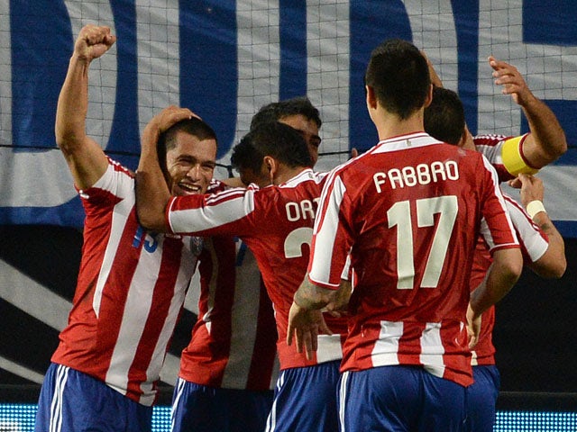 Paraguay´s players celebrate scoring during the friendly football match Germany vs Paraguay on August 14, 2013