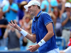 John Isner celebrates his win over Novak Djokovic during the Western & Southern Open on August 16, 2013