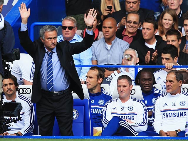 Chelsea manager Jose Mourinho waves to the crowd as he is welcomed back Chelsea fans before kick off against Hull on August 18, 2013