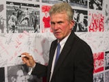 Former Bayern Munich headcoach Jupp Heynckes signs a wall during a ceremony for the 50th anniversary of the German football premier league Bundesliga on August 6, 2013 