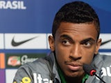 Brazil's midfielder Luiz Gustavo listens to comments during a press conference in Rio de Janeiro on June 28, 2013