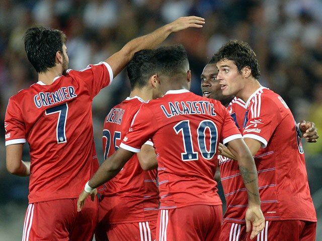 Lyon's French midfielder Yoann Gourcuff celebrates with teammates after scoring a goal during the French L1 football match agaisnt Sochaux on August 16, 2013