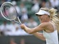 Russia's Maria Sharapova returns against Portugal's Michelle Larcher De Brito during their second round women's singles match on day three of the 2013 Wimbledon Championships tennis tournament at the All England Club in Wimbledon, southwest London, on Jun