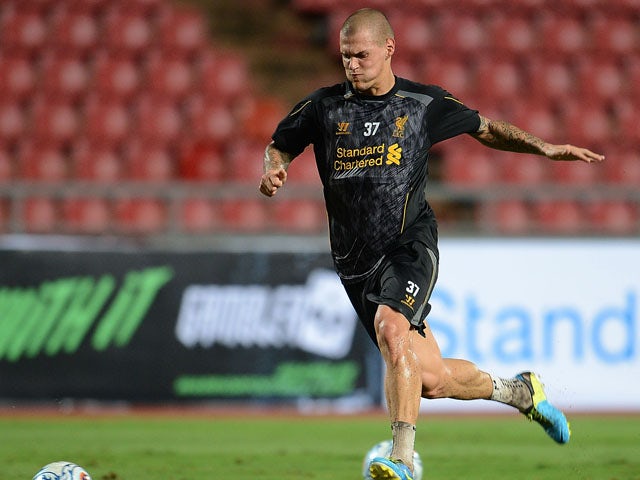 Martin Skrtel runs with the ball during a Liverpool FC training session at Rajamangala Stadium on July 27, 2013