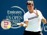 Milos Roanic in action against Janko Tipsarevic during the Western & Southern Open on August 14, 2013