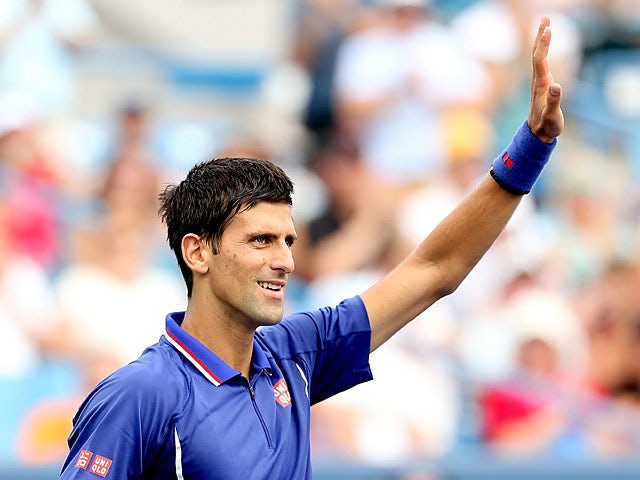 Novak Djokovic waves to the crowd as he celebrates his win against David Goffin during the Western & Southern Open on August 15, 2013