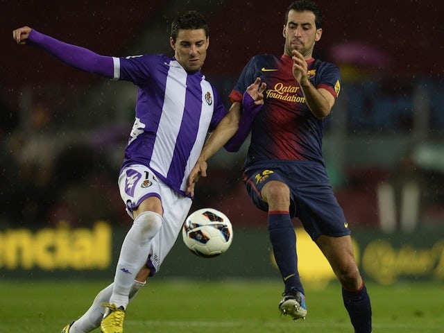 Real Valladolid's Oscar Gonzalez battles with Sergio Busquets of Barcelona on May 19, 2013