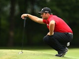 Patrick Reed lines up a putt on the first hole in the final round of the Wyndham Championship on August 18, 2013