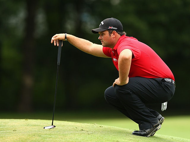 Patrick Reed lines up a putt on the first hole in the final round of the Wyndham Championship on August 18, 2013