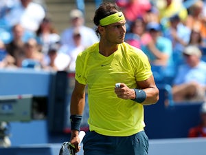 Rafael Nadal celebrates after winning a point against John Isner during the men's final of the Western & Southern Open on August 18, 2013