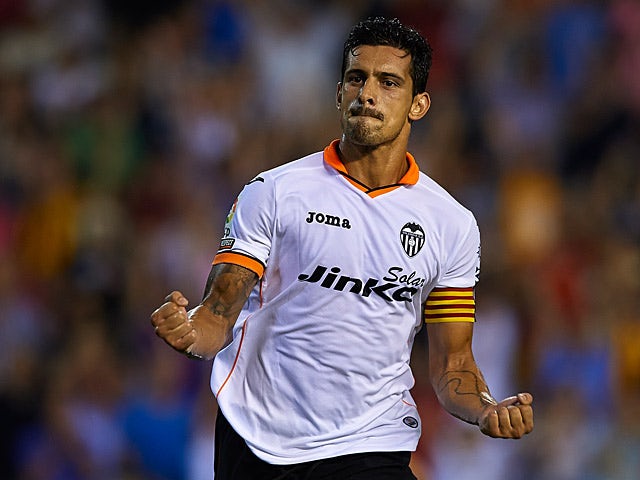 Valencia's Ricardo Costa celebrates scoring against Malaga on August 17, 2013