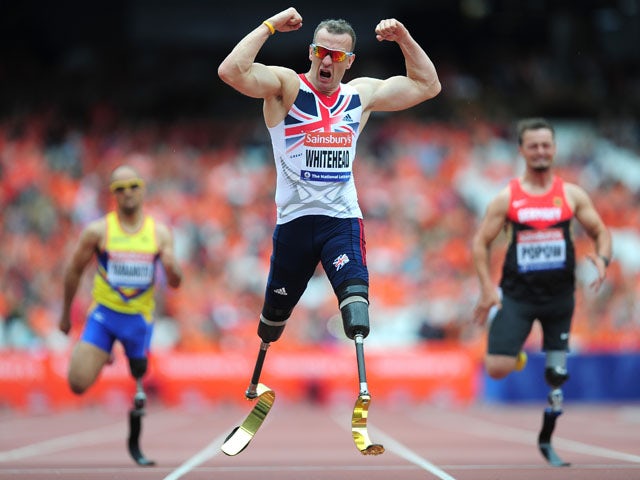 Richard Whitehead of Great Britain celebrates as he crosses the line first in the Mens T42 200mduring day three of the Sainsbury's Anniversary Games - IAAF Diamond League 2013 at The Queen Elizabeth Olympic Park on July 28, 2013