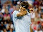 Roger Federer of Switzerland wipes his face between points while playing Rafael Nadal of Spain during the Western & Southern Open on August 16, 2013
