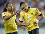 Sochaux's Ryad Boudebouz is congratulated by team mate Yassin Mikari after scoring the opening goal against Lyon on August 16, 2013