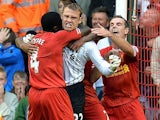 Liverpool goalkeeper Simon Mignolet is congratulated by team mates after saving a penalty against Stoke on August 17, 2013