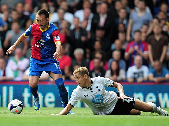 Palace's Stephen Dobbie beats Spurs' Michael Dawson to the ball on August 18, 2013