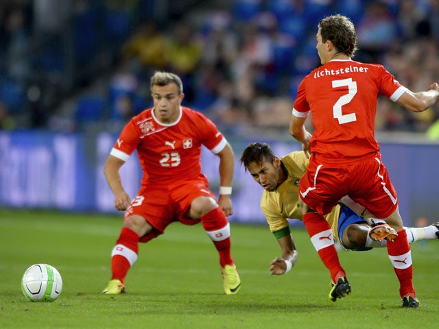 Brazilian forward Neymar is tackled during the International Friendly against Switzerland on August 14, 2013 