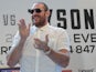 Heavyweight boxer Tyson Fury claps during a press conference on July 11, 2013