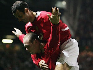 Wayne Rooney of Manchester United celebrates his second goal with Ryan Giggs during the UEFA Champions League Group D match between Manchester United and Fenerbahce SK at Old Trafford on September 28, 2004