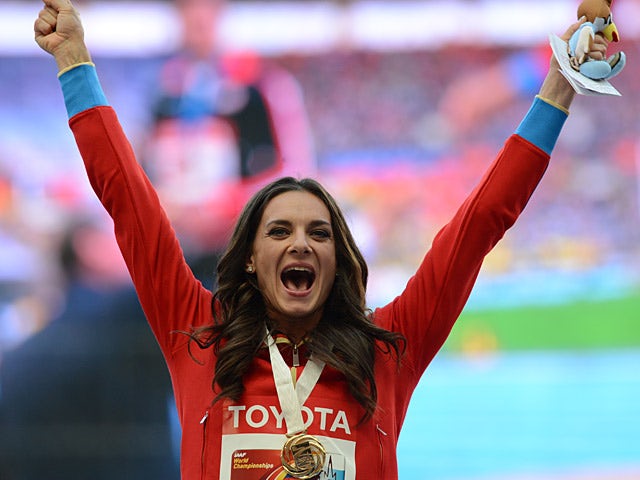 Yelena Isinbayeva on the podium after receiving her gold medal for the women's pole vault during the World Championships on August 15, 2013