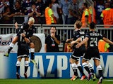 Real Sociedad's Antoine Griezmann is congratulated by team mates after scoring the opening goal against Lyon on August 20, 2013