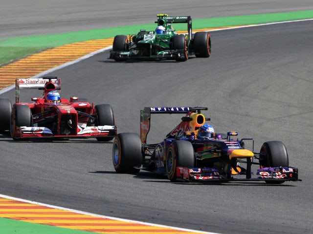 Ferrari's Spanish driver Fernando Alonso, Caterham F1 Team's Dutch driver Guido Van Der Garde and Red Bull Racing's German driver Sebastian Vettel drive during the second practice session at the Spa-Francorchamps circuit in Spa on August 23, 2013 