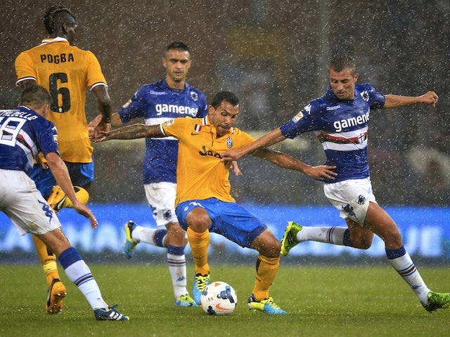Juve striker Carlos Tevez shields the ball in rain soaked conditions against Sampdoria on August 24, 2013