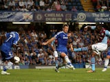 Christian Benteke of Aston Villa shoots past John Terry of Chelsea to score a goal to level the scores at 1-1 during the Barclays Premier League match between Chelsea and Aston Villa at Stamford Bridge on August 21, 2013