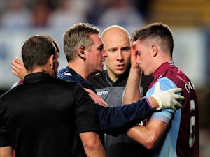 Ciaran Clark of Aston Villa receives treatment for a cut to his head during the Barclays Premier League match between Chelsea and Aston Villa at Stamford Bridge on August 21, 2013