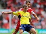 Sunderland's Craig Gardner battles for the ball against Southampton on August 24, 2013