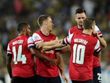 Arsenal's Aaron Ramsey celebrates with teammates after scoring the second goal against Fenerbahce during their UEFA Champions League Play Off first leg match at Sukru Saracoglu Stadium in Istanbul on August 21, 2013