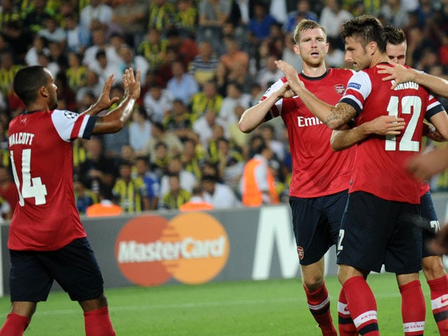 Arsenal's Olivier Giroud celebrates with teammates after scoring the third goal against Fenerbahce during their UEFA Champions League Play Off first leg match at Sukru Saracoglu Stadium in Istanbul on August 21, 2013