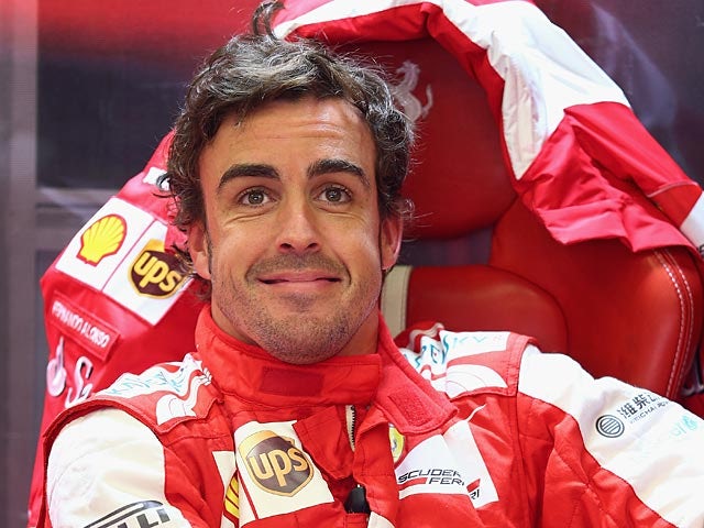 Fernando Alonso smiles as he prepares for the final qualifying session of the Belgium Grand Prix on August 24, 2013