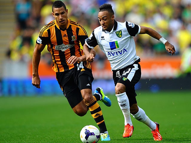 Hull's Jake Livermore and Norwich's Nathan Redmond battle for the ball on August 24, 2013