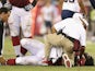 Cards' Jonathan Cooper lays stricken with a broken leg during a game with San Diego on August 24, 2013