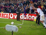 Luis Figo is pelted with lighters and coins as he prepares to take a corner.