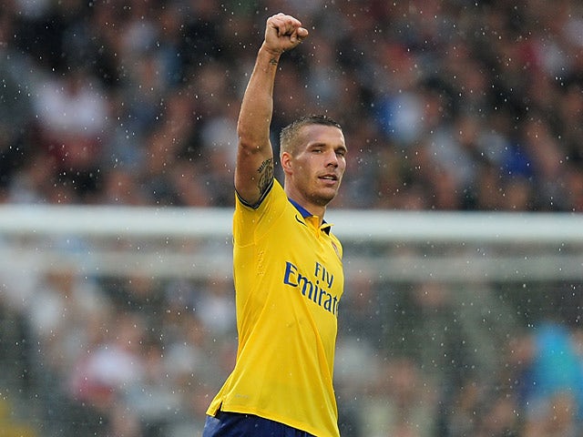 Arsenal's Lukas Podolski celebrates after scoring his team's second goal against Fulham on August 24, 2013