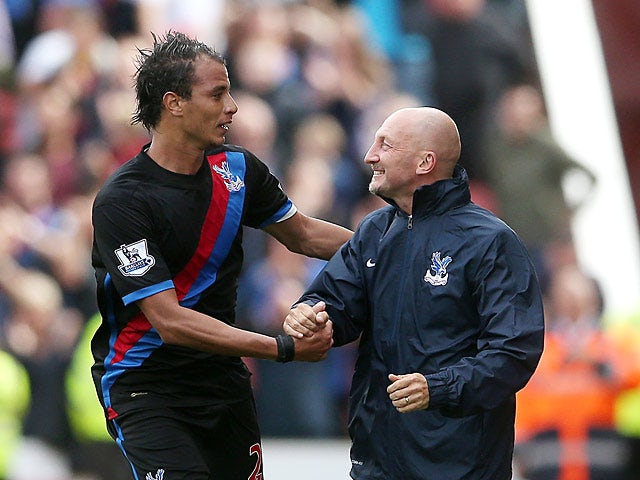 Palace's Marouane Chamakh celebrates with manager Ian Holloway after scoring the opening goal against Stoke on August 24, 2013