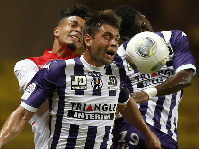 Monaco's French forward Emmanuel Riviere vies with Toulouse Serbian defender Pavle Ninkov and defender Serge Aurier during a French L1 football match between Monaco and Toulouse on August 23, 2013