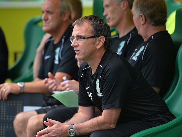 Hibs boss Pat Fenlon sits in the dugout during a game with Motherwell on August 4, 2013