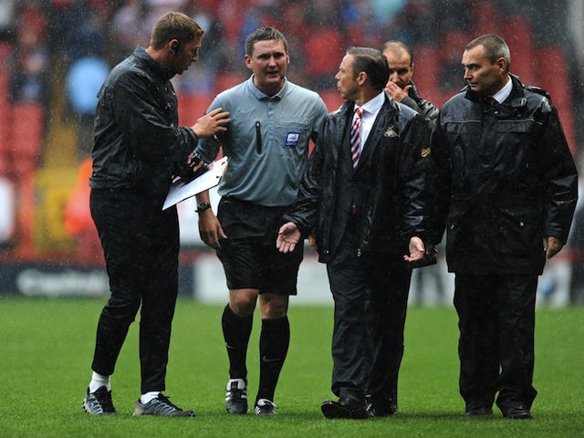 Doncaster boss Paul Dickov complains to the officials after the game with Charlton is stopped due to a waterlogged pitch on August 24, 2013