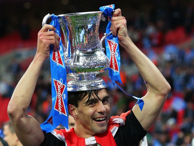 Paul Scharner of Wigan Athletic celebrates his team's victory after the FA Cup with Budweiser Final between Manchester City and Wigan Athletic at Wembley Stadium on May 11, 2013