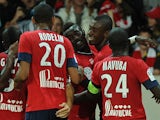Lille's Salomon Kalou is congratulated by team mates after scoring the opening goal against Saint-Etienne on August 25, 2013