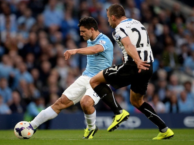 Man City striker Sergio Aguero shoots to score the second goal against Newcastle on August 19, 2013