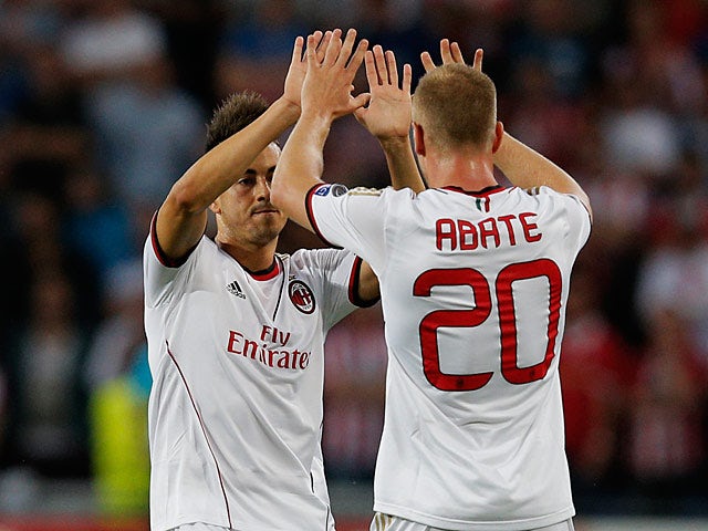 AC Milan's Stephan El Shaarawy celebrates with team mate Ignazio Abate after scoring the opening goal against PSV Eindhoven on August 20, 2013